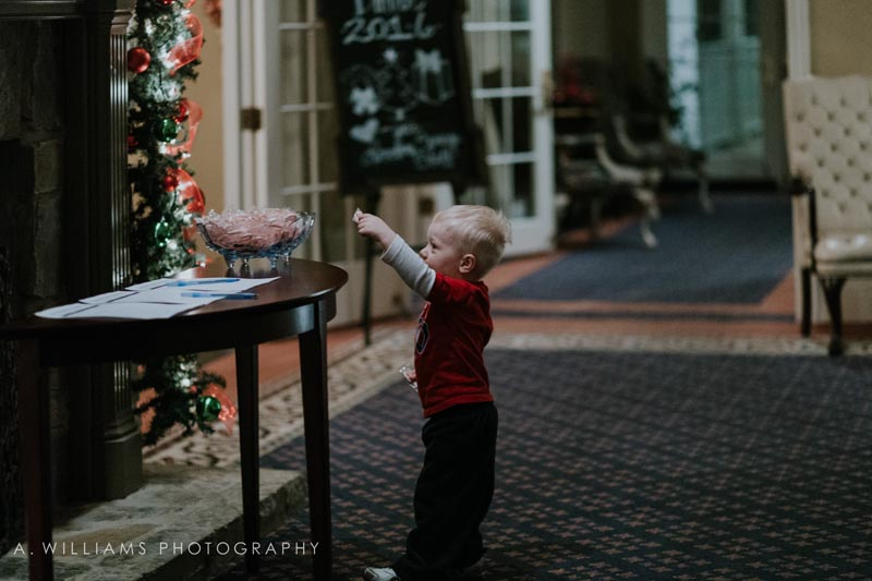 child taking peppermint from candy dish